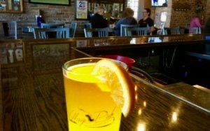 Glass of Bells Oberon beer sits on a bar