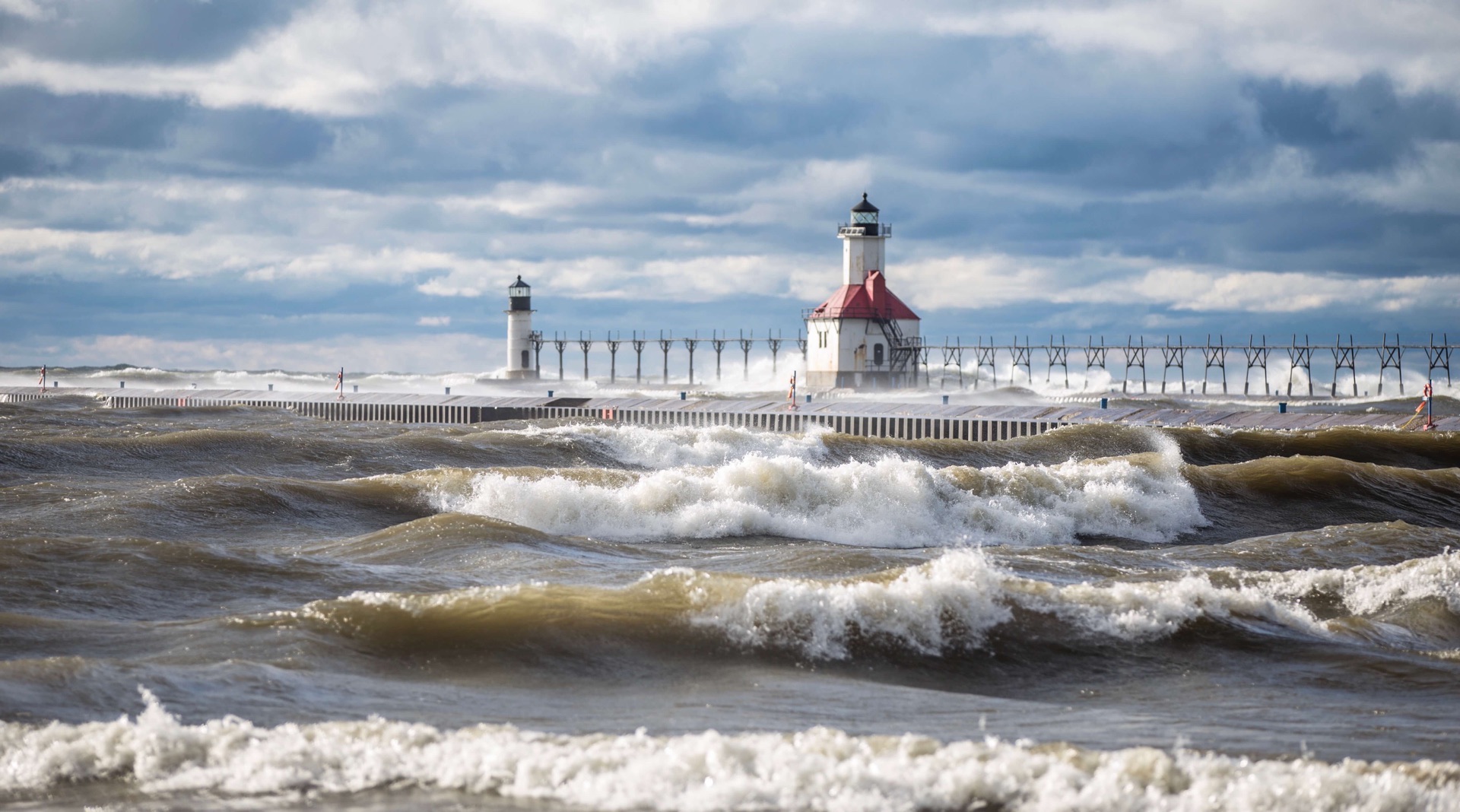 Rough seas on Lake Michigan bash lighthouses and pier