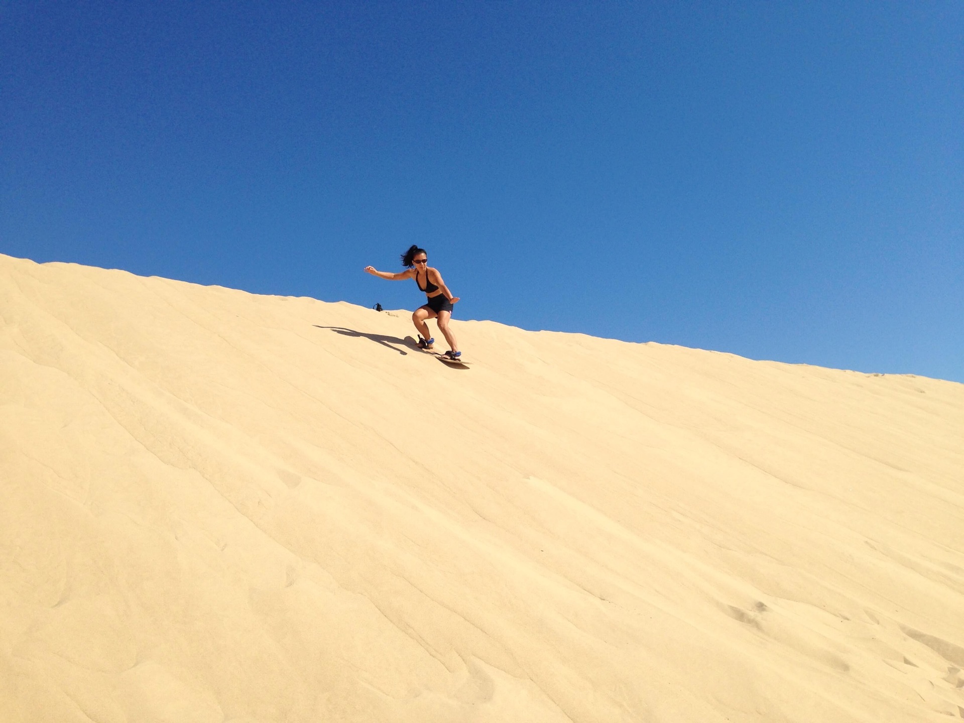 Sand boarding at Silver Lake Sand Dunes, Mears