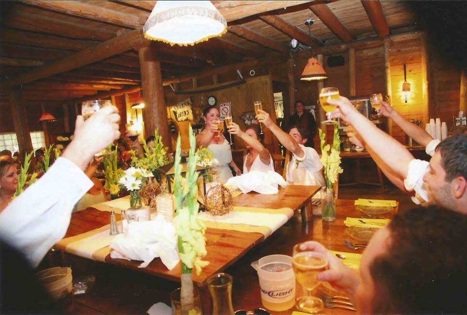 People make a toast during a wedding reception at Presque Isle Lodge