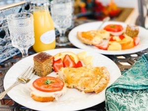 Plated breakfasts, glasses, orange juice as served at Prairieside Suites