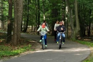 Two couples wearing jackets bike on a trail near Glen Arbor