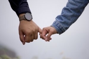 Couple holding hands. Photo illustration.