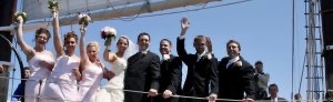 Wedding party waving on Tall Ship Manitou
