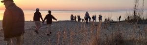 People gather for sunset on Lake Michigan beach in Glen Arbor