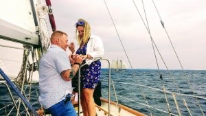 Loving couple get engaged aboard Sailing Yacht Scout in Grand Traverse Bay