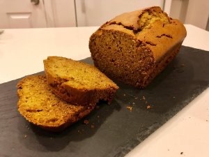 Sliced loaf of pumpkin bread on a kitchen counter.