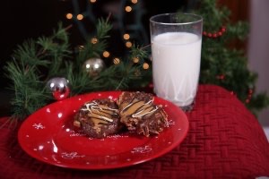 Homemade cookies and milk in front of a Christmas tree