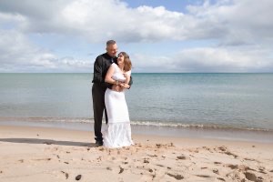 Newlywed couple celebrate their elopement on the beach at Huron House
