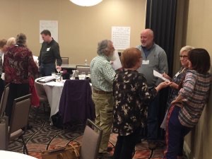 Small groups of attendees exchange ideas at innkeeper conference