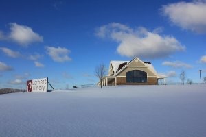 The main building of 12 Corners Winery sits on a snow-covered hill in winter