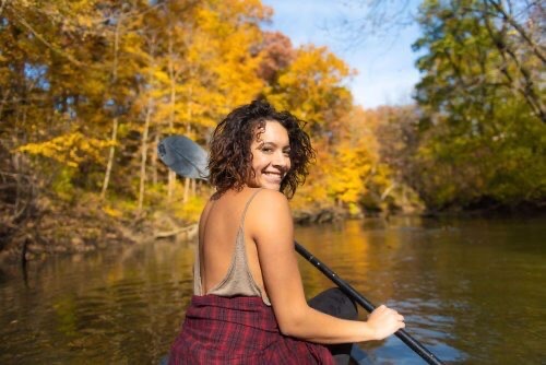 Woman paddles kayak on the Galien River through the Goldberry Woods property