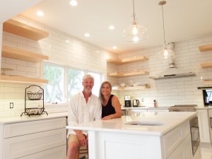 Lance and Joanne Murphy sit in the contemporary kitchen of the historic Port Austin home they are renovating as a B&B