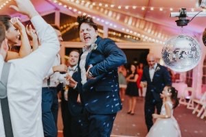 Wedding guests dance under a tent at The Morris Estate
