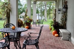Pumpkins and cornstalks decorate the front porch at Villa on Verona
