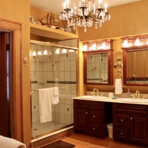 Myer-Rosa Suite at Himelhoch B&B in Caro has a bathroom with a large heated-tile shower, double sinks and a chandelier.