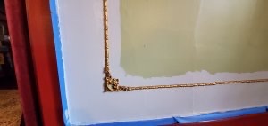 Detail closeup of gold frame molding the innkeepers wanted to preserve