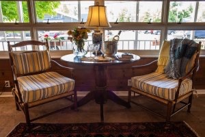 Unseen couple about to celebrate in cozy chair and table arrangement at Glen Arbor B&B