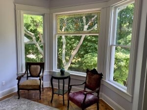 Bay window in Room 3 has two mismatched chairs and a round table.