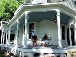 Lance and Joanne Murphy sit on the front porch of Port Austin B&B