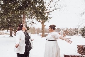 Two women who just got married on a snowy day
