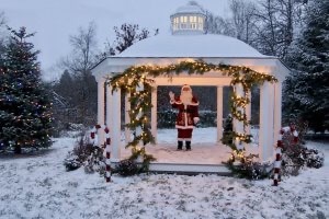 Santa Claus stands in a lighted, snow-covered gazebo at Stag’s Leap Farm