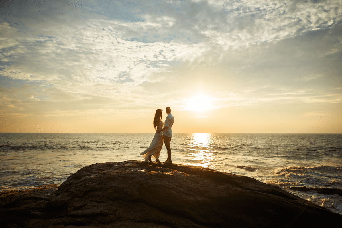 Young wedding couple on the beach at sunset