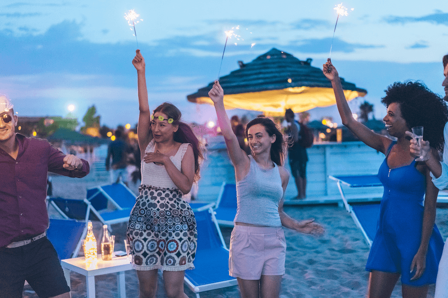 Young people with firecrackers on the beach