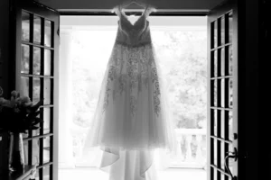 Wedding dress hanging in an open doorway