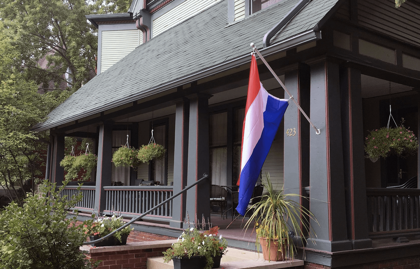 Victorian porch with a flag