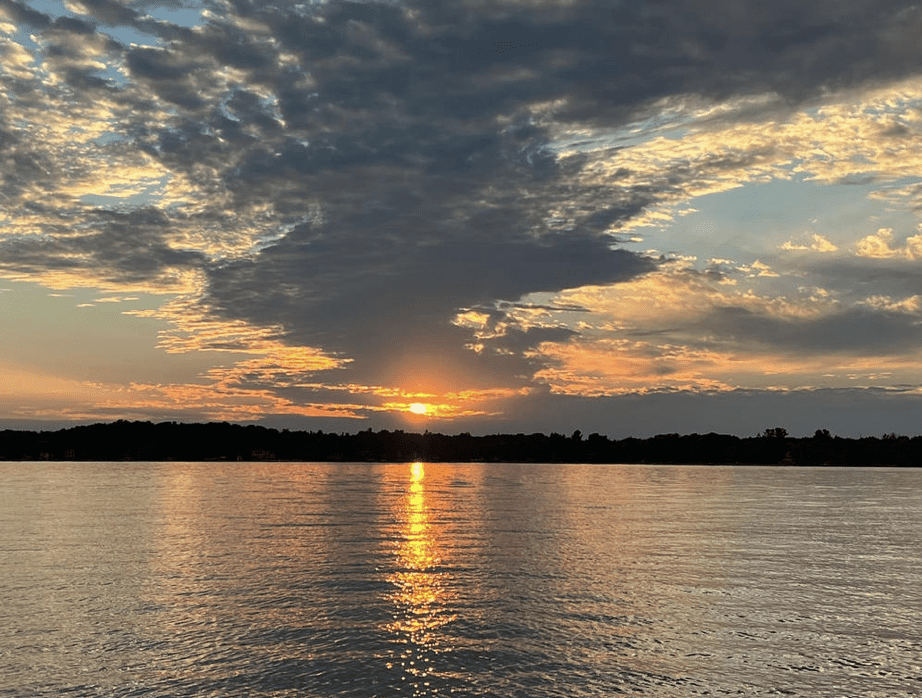 Sunset on a lake with beautiful clouds above