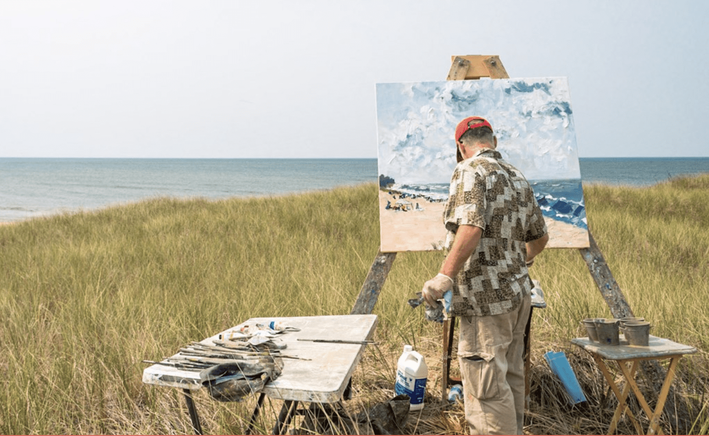 Artist painting on a beach in Saugatuck, michigan's Art Coast