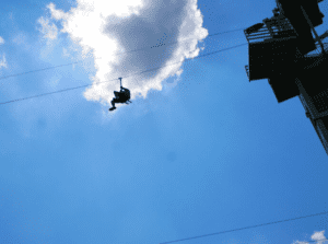 Ziplining with white cloud above