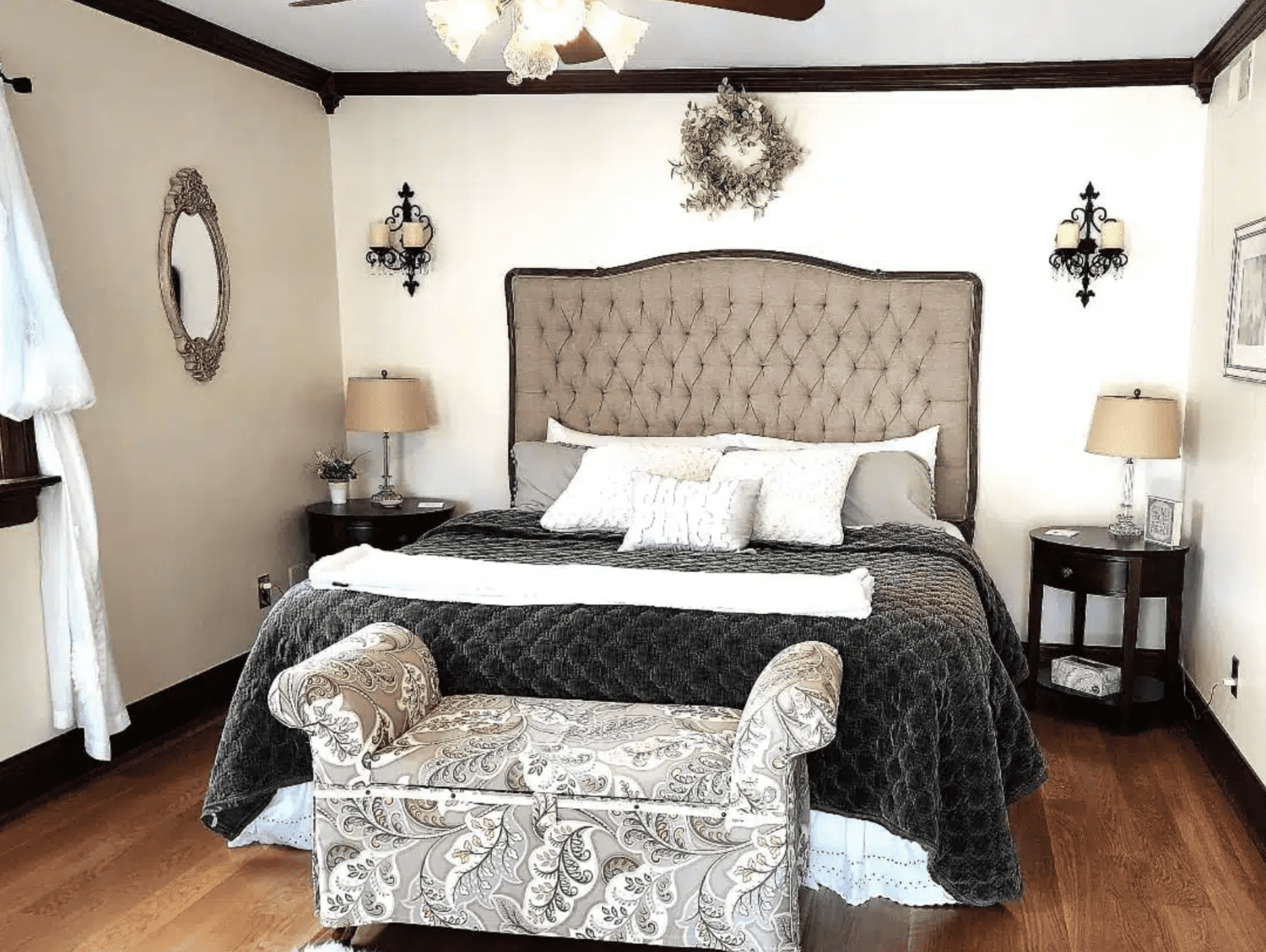Large headboard with settee at the base of the bed at Maple Cove Bed and Breakfast