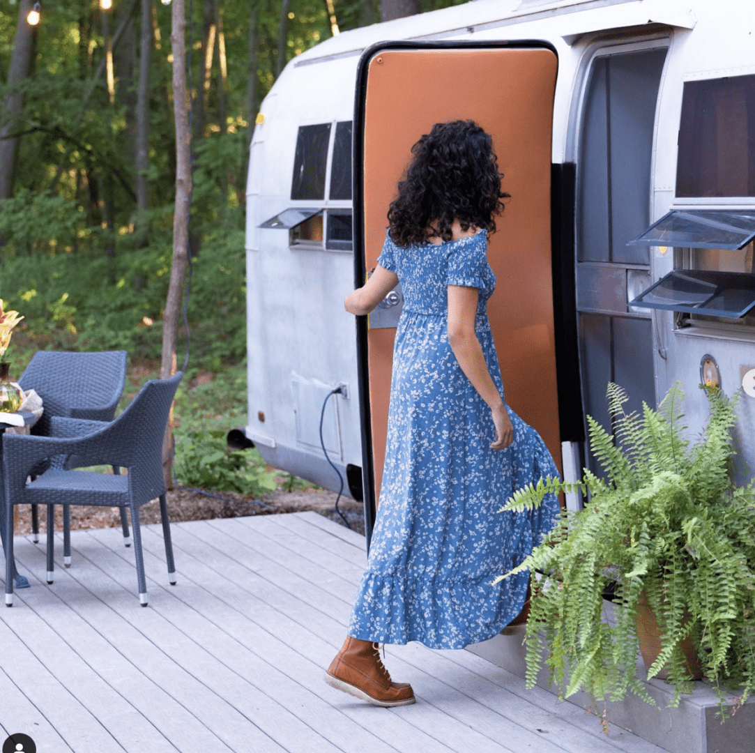 Woman stepping into a vintage camper
