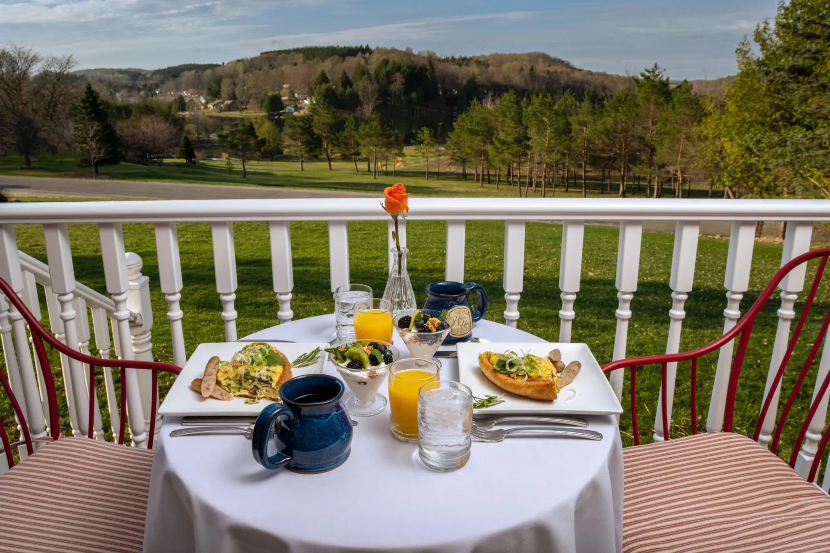 Breakfast setting for two on the porch at House on the Hill Bed and Breakfast Overlooking beautiful expansive grounds.