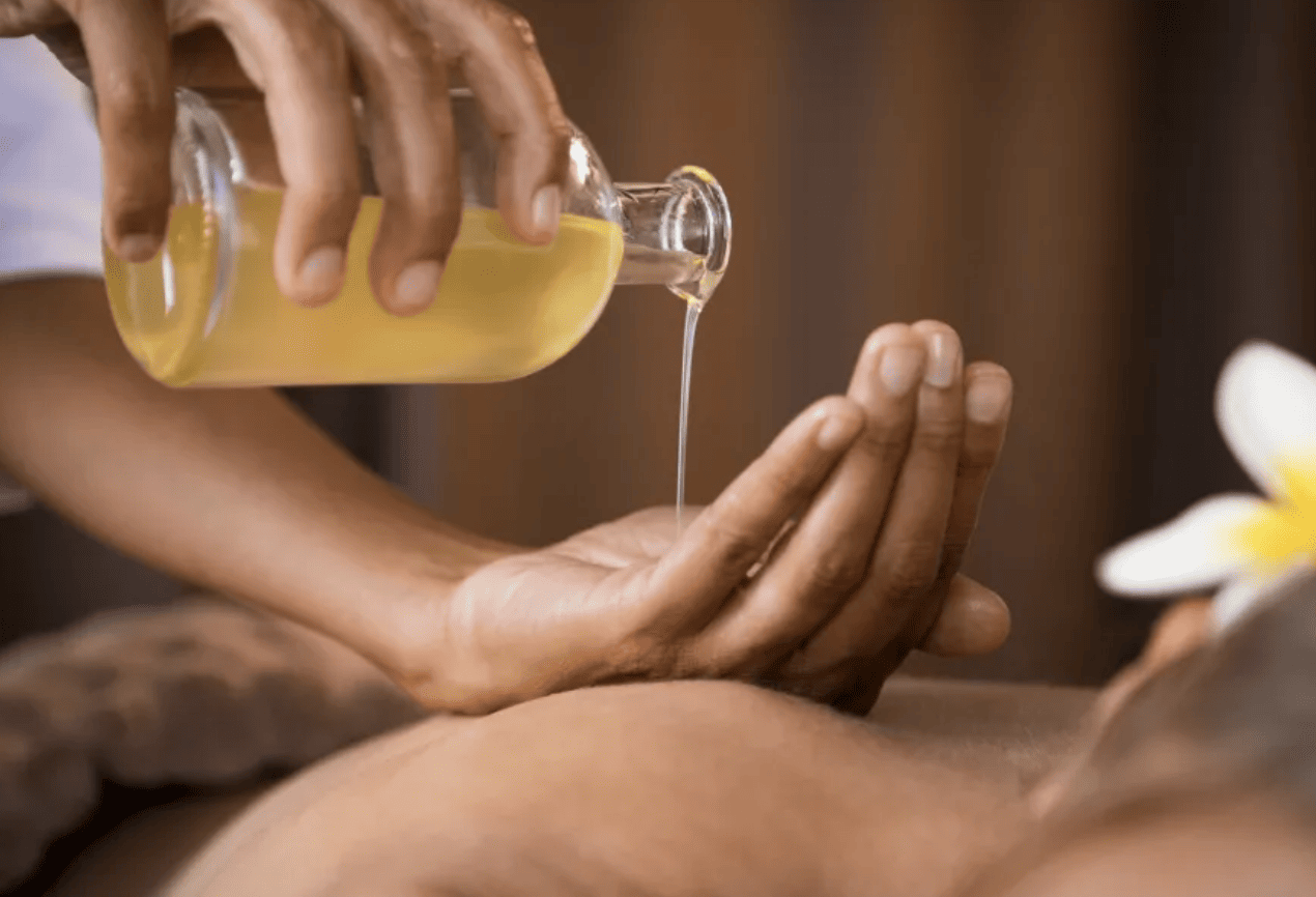 Massage oils being poured into a hand
