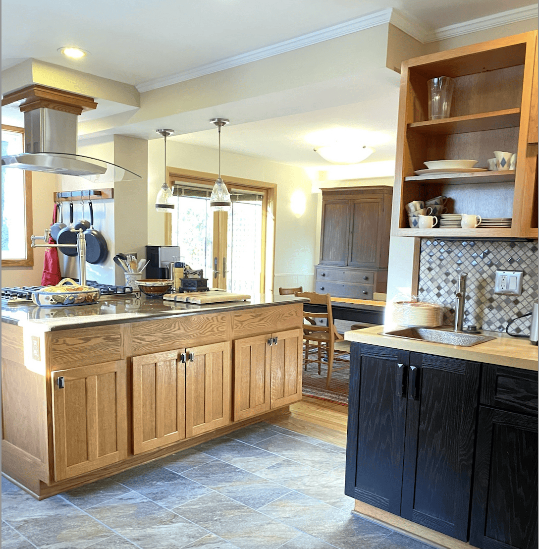 Chef Kitchen with Oak Cabinetry and modern fan