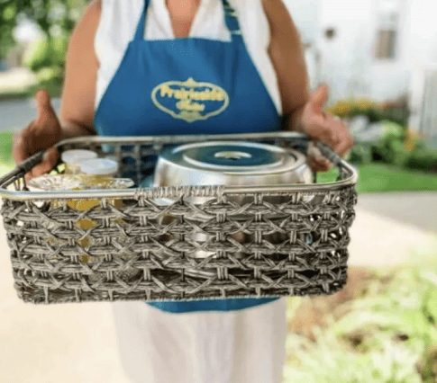 Woman delivering breakfast in a basket tray 