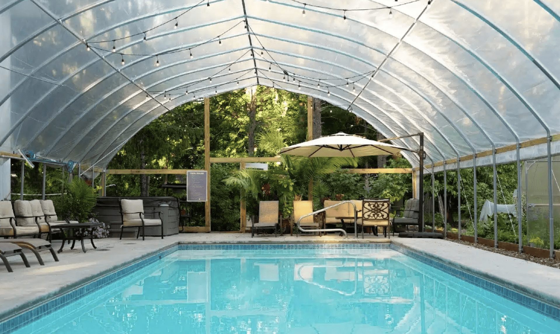 Pool with cover and umbrella seating at Goldberry Woods