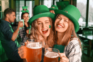 Two young girls celebrating St Patricks Day in a pub