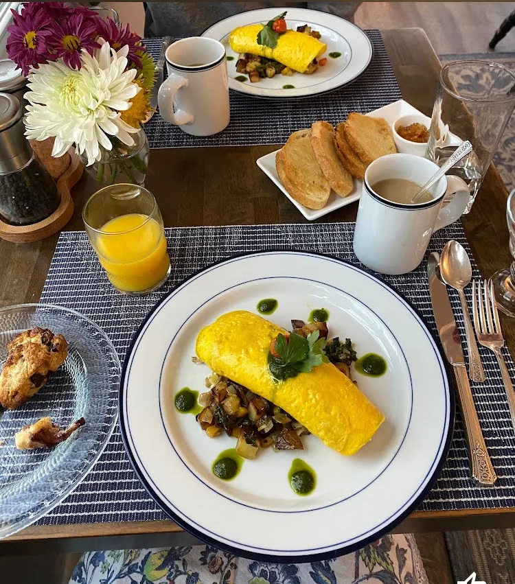 Breakfast plate with orange juice and flowers