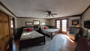 Two queen beds with a ceiling fan at Brochers AuSable